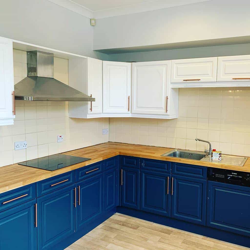 white and blue cabinets butcher block countertop kitchen