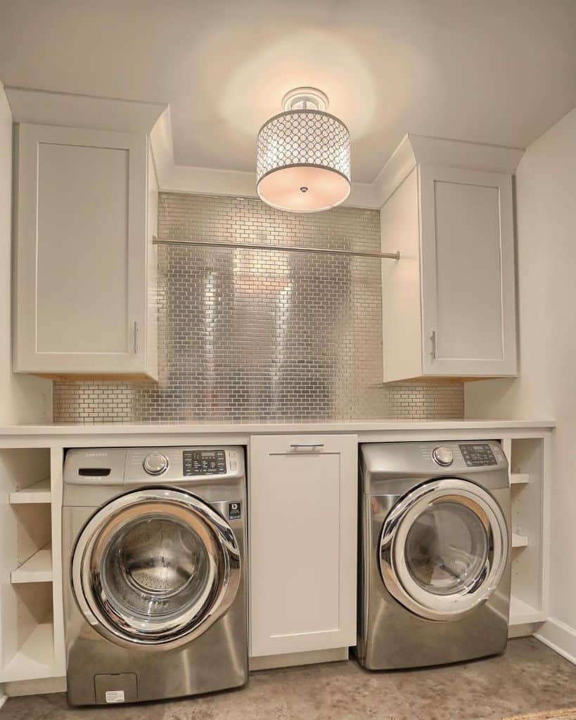 white cabinet laundry room silver tile backsplash washer and dryer