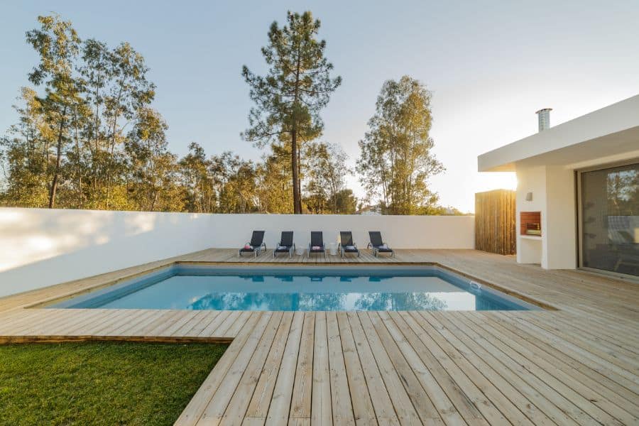 simple wood deck pool patio with sun loungers