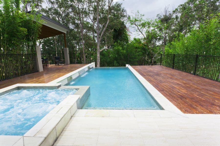 pool and spa with wood deck