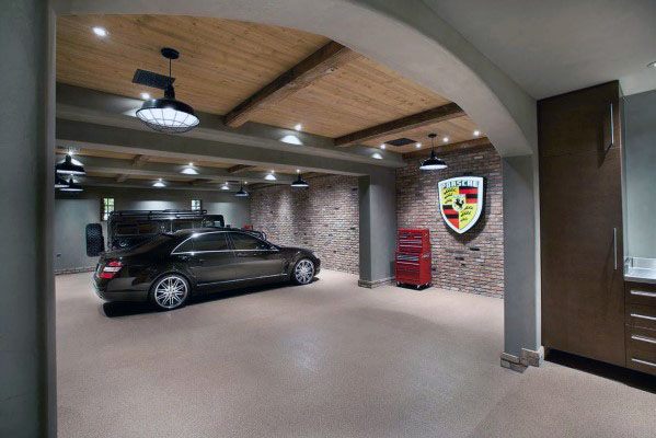 Garage with rustic wood ceiling, brick accent wall, and industrial lighting fixtures.