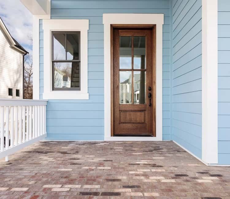 wood trim window with light blue exterior paved patio