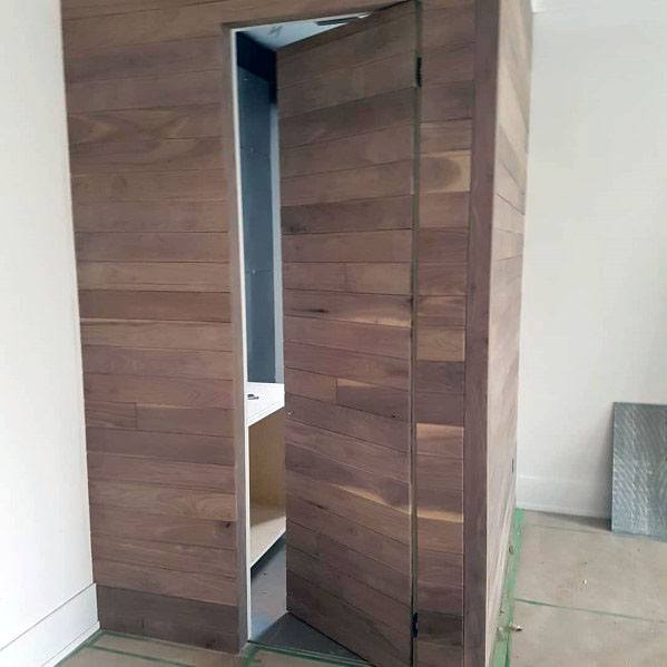wood wall hidden bathroom door