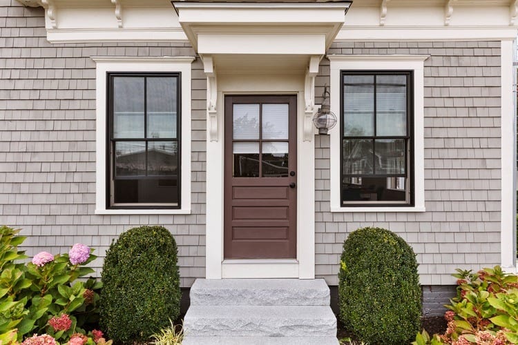 wooden brown front door and white window
