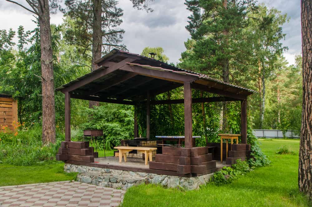 simple wooden gazebo bench seating table stone base
