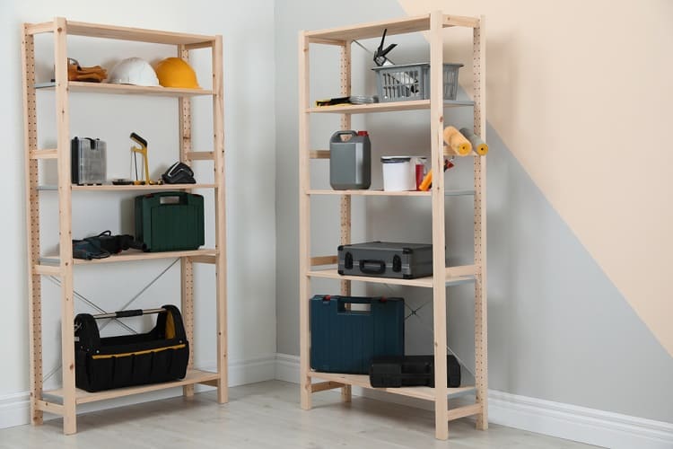 Wooden shelves with tools and storage boxes in a clean, organized room.