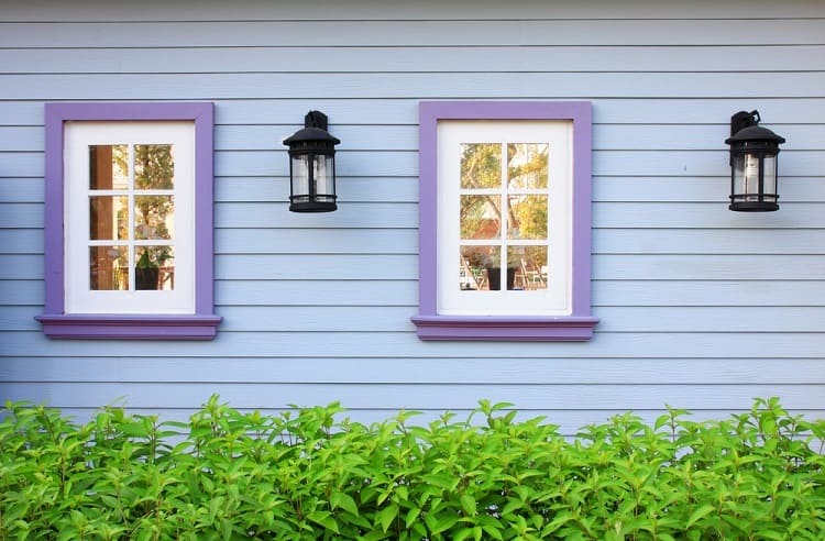 wooden window purple trim and blue wood wall