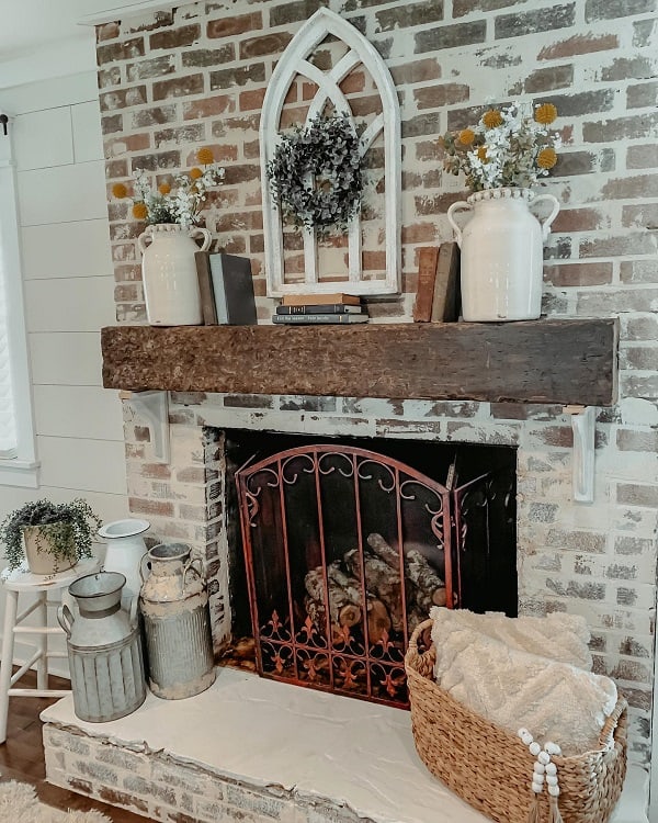 rustic brick fireplace with wood beam mantel