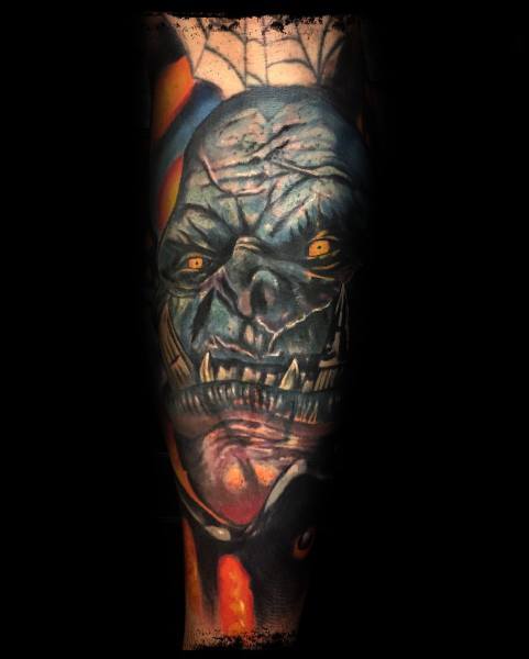Dark fantasy tattoo of an undead creature from World of Warcraft, featuring glowing yellow eyes, decayed skin, and eerie shading, inked on the forearm.