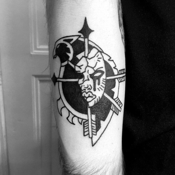 Bold black ink tattoo of the Horde crest from World of Warcraft, featuring sharp lines, a stylized orc face, and tribal elements, inked on the forearm.