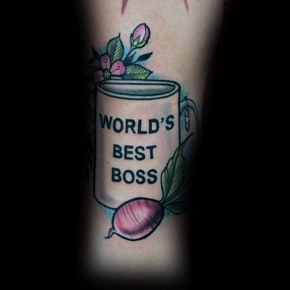 Color tattoo of Michael Scott’s "World’s Best Boss" mug from *The Office*, decorated with flowers and a beet, referencing Dwight Schrute.