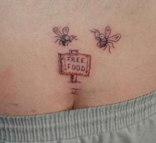 A humorous tattoo of two flies hovering over a 'Free Food' sign, placed near the lower back for a cheeky design.
