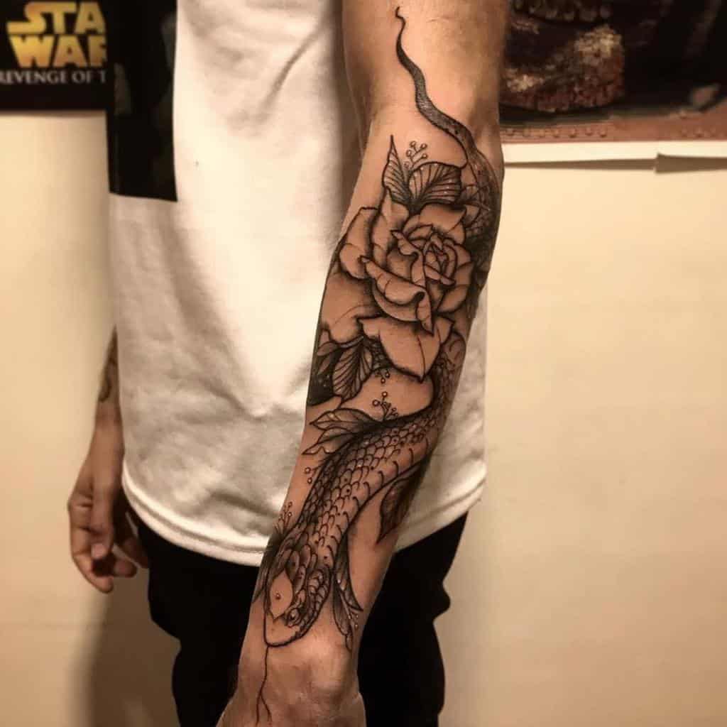 Black ink tattoo of a snake coiling around a forearm with a large rose at the center, featuring detailed scales and petals