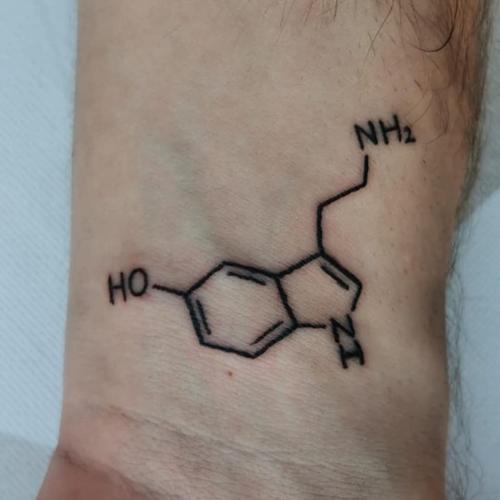 Tattoo of a serotonin molecule on a wrist