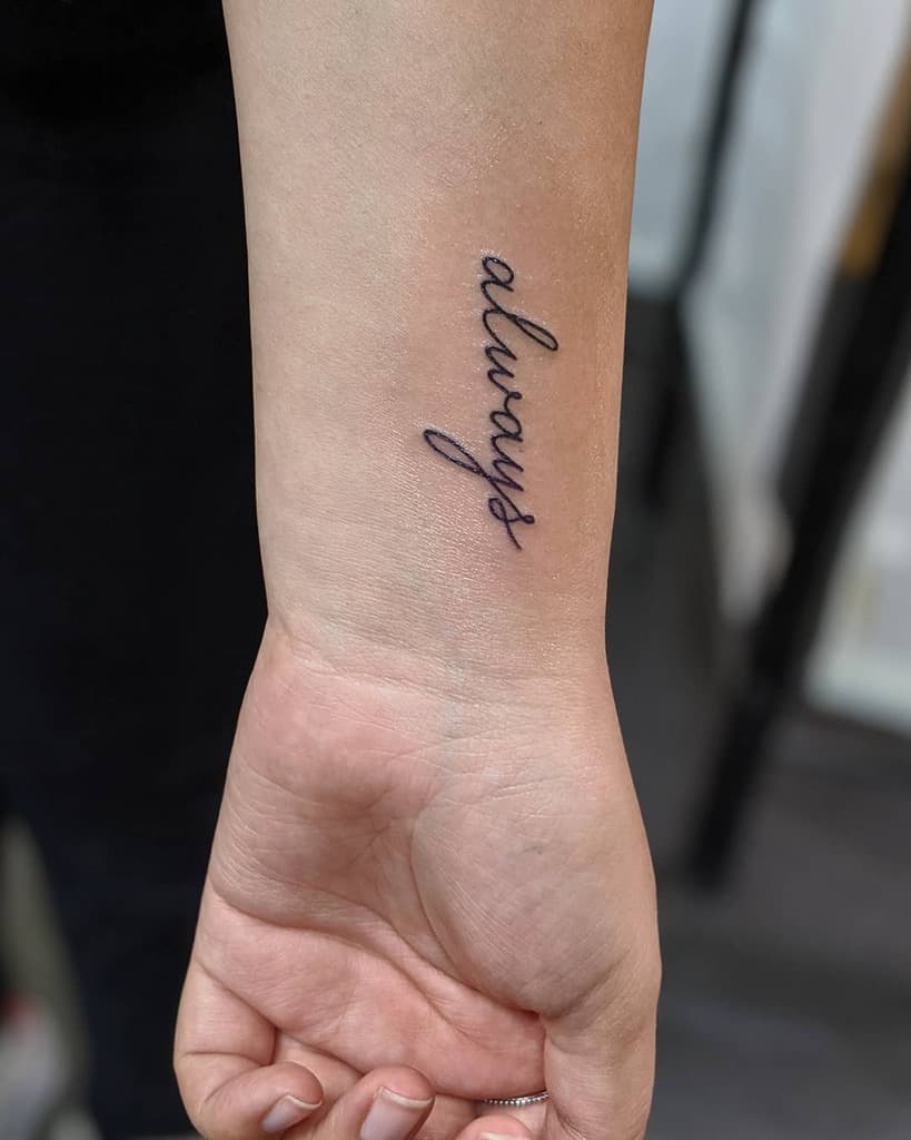 A wrist tattoo reads "always" in elegant cursive script