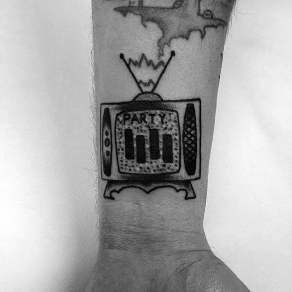 Retro TV tattoo on the wrist featuring the Black Flag bars on the screen with the word “PARTY” above, blending punk and vintage flair.