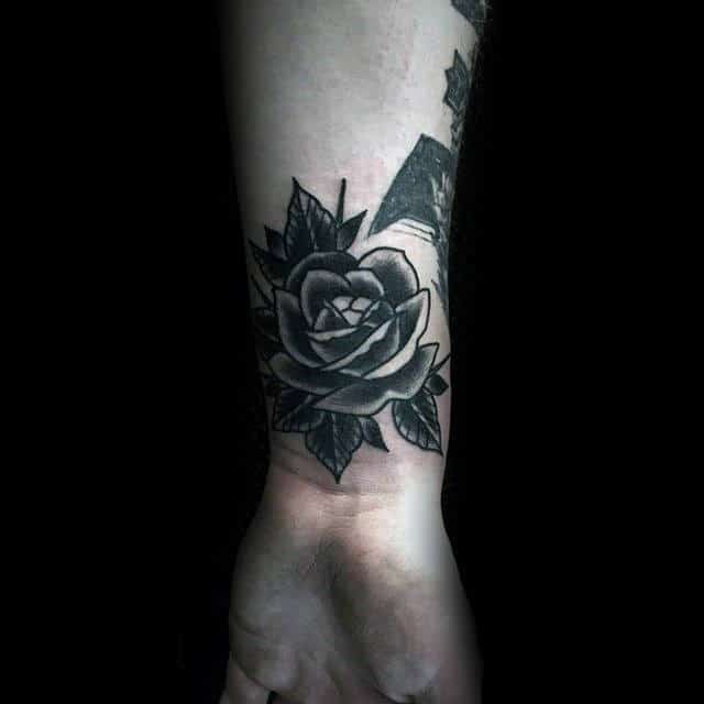 Black rose tattoo on a wrist