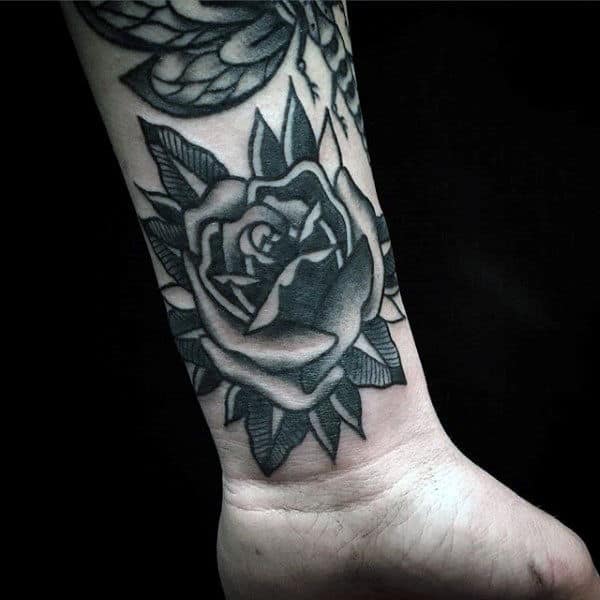 Black and gray rose tattoo on a wrist