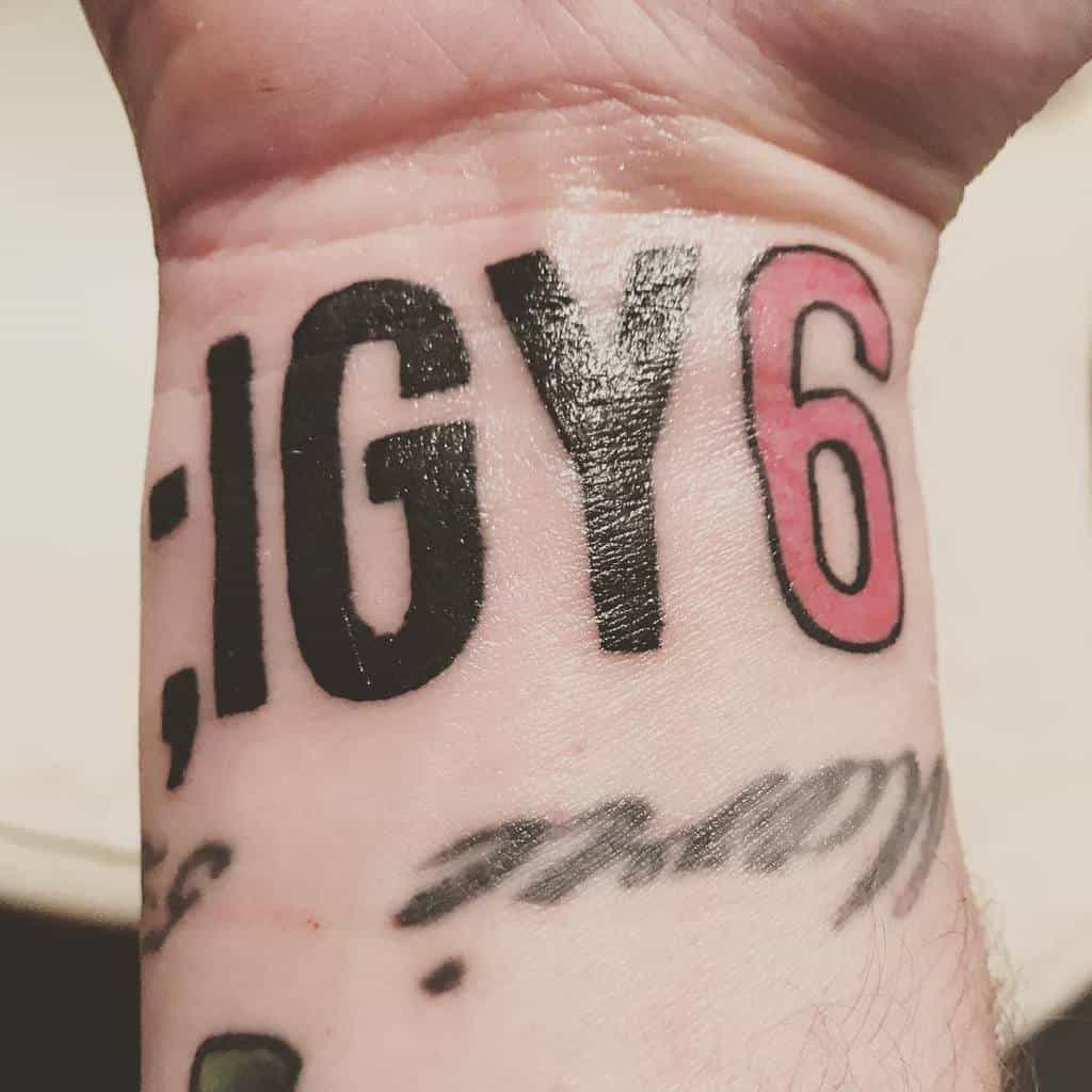 Tattoo on a wrist reading "; IGY6" with the number 6 in red