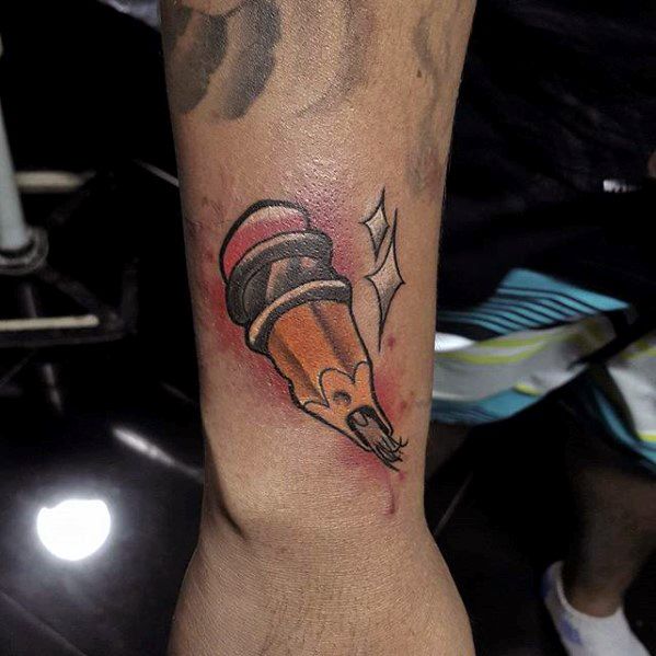 Tattoo of a snapped pencil on an arm, featuring a comic-style shine that adds a touch of whimsy