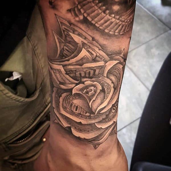 Tattoo of a rose made from dollar bills on an arm