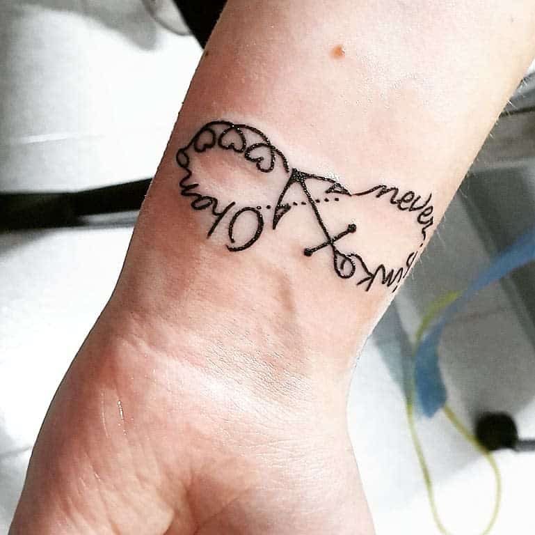 This tattoo shows the word "never" connecting two parts of the infinity symbol, representing eternal or unbroken love. It also includes "forever" with a unique design, blending time and commitment within a lasting loop.