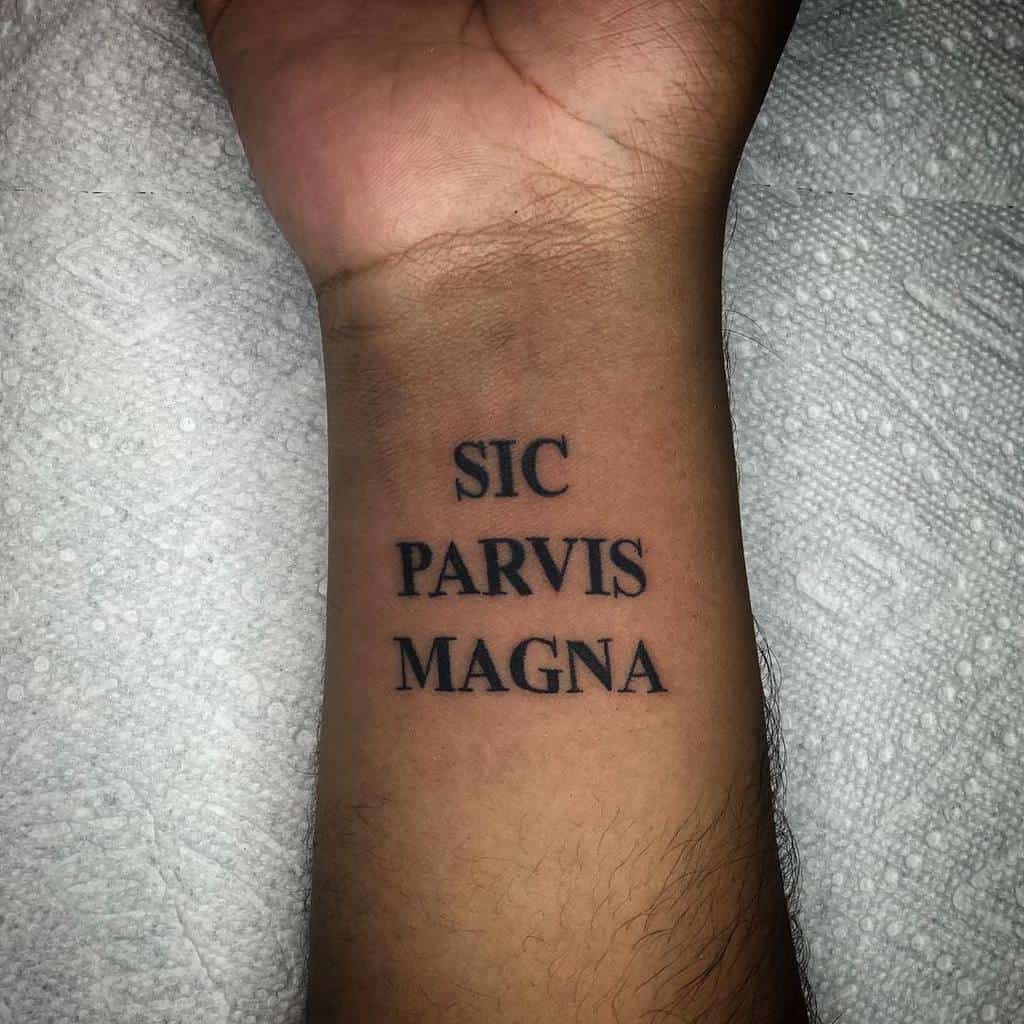 A wrist tattoo reads "Sic Parvis Magna" 