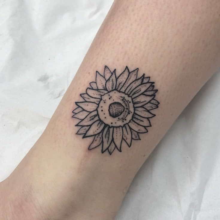 Tattoo of a sunflower on an arm