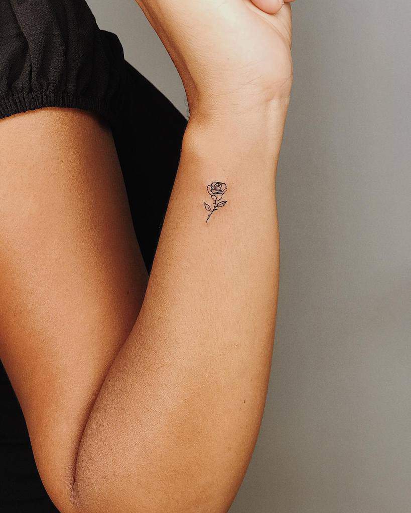 A small rose tattoo on a wrist
