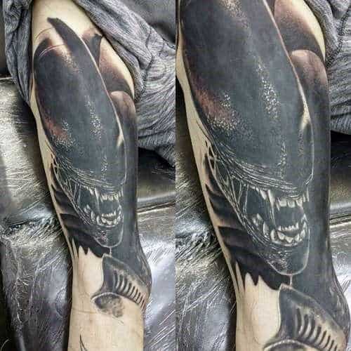 Dark and realistic Xenomorph tattoo sleeve showing the alien snarling with shadowy tones, sharp teeth, and intense contrast detailing.