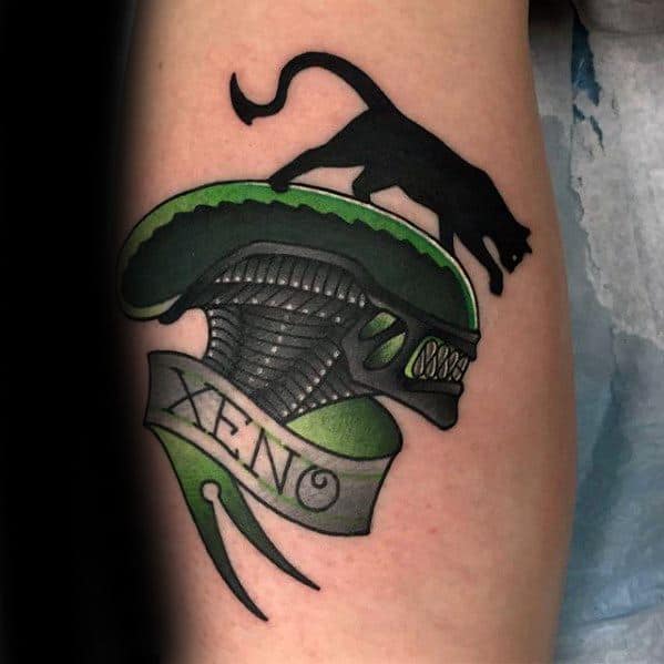 Neo-traditional Xenomorph tattoo with bold black and green colors, featuring a snarling alien head, a black cat, and a "XENO" banner.