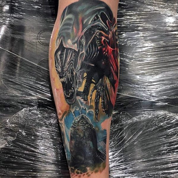 Colorful Xenomorph leg tattoo showing the alien in a dramatic pose with vivid lighting, electric blue background, and an opened alien egg.