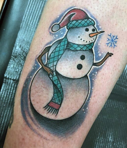 Christmas tattoo of a cheerful snowman wearing a Santa hat and plaid scarf, reaching for a snowflake, designed with soft shading for a festive winter look.