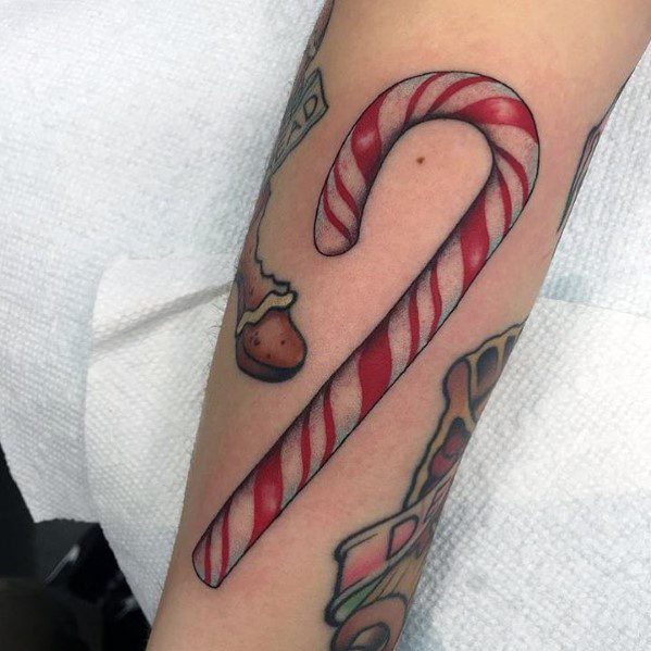 Christmas tattoo of a classic red and white striped candy cane, designed with bold shading and crisp lines for a festive and timeless holiday look.