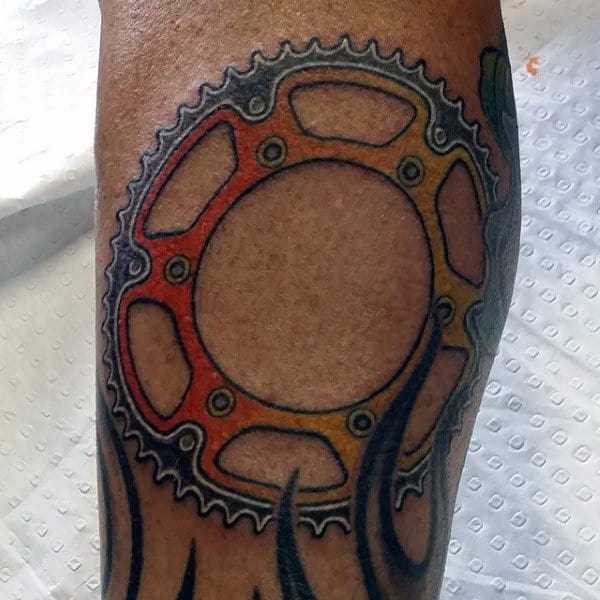 Yellow And Orange Male Sprocket Leg Tattoo