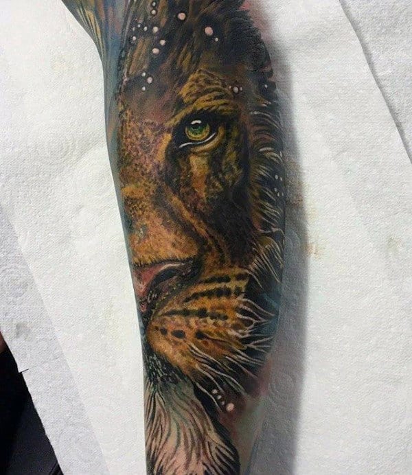 Arm tattoo of a realistic lion's face