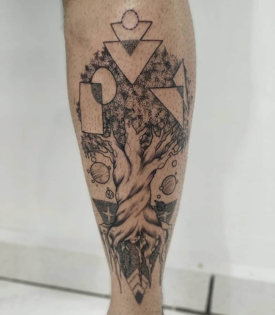 The tattoo showcases Yggdrasil with geometric shapes and celestial elements, combining Norse mythology with a modern, abstract style.