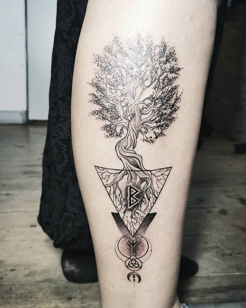 This tattoo features a detailed tree of life with geometric elements, Norse runes, and spiritual symbols, representing growth and wisdom.