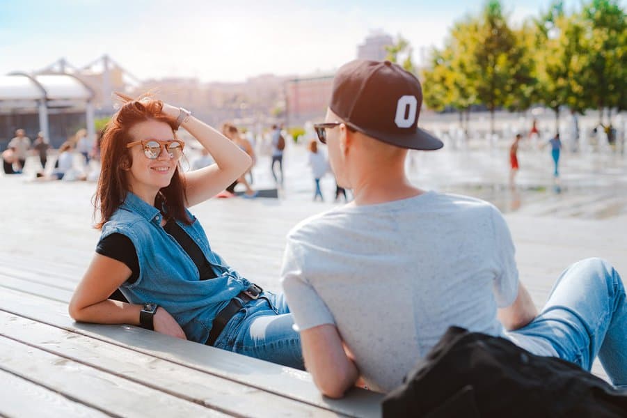 young couple has fun chatting in a city park
