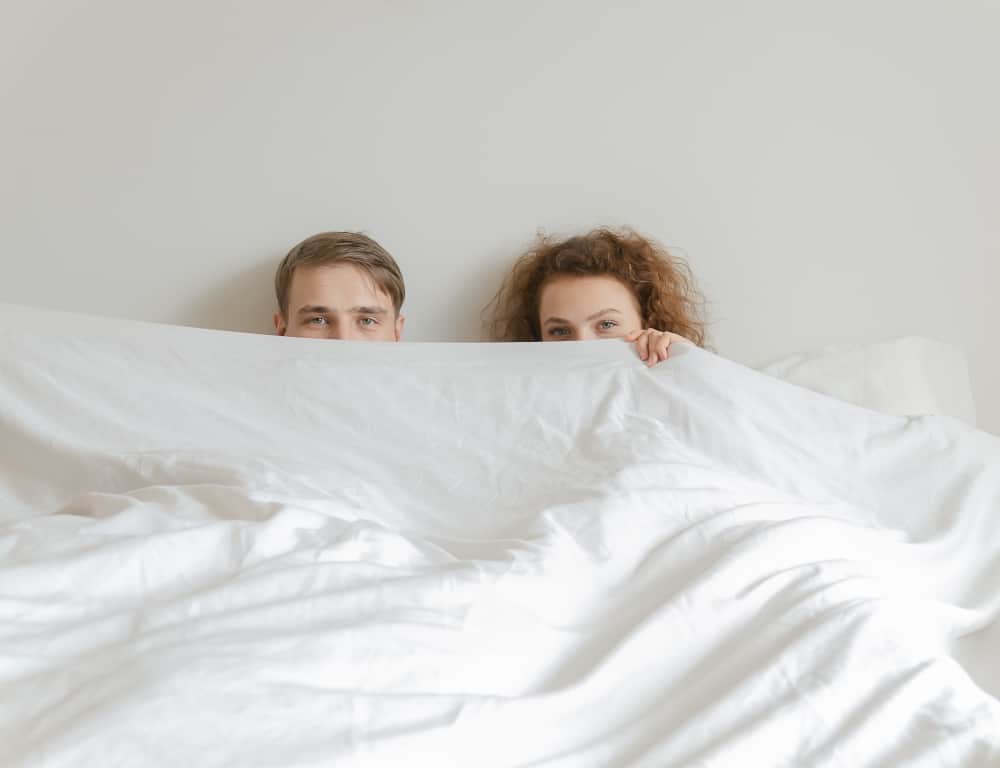young couple slept together in bed