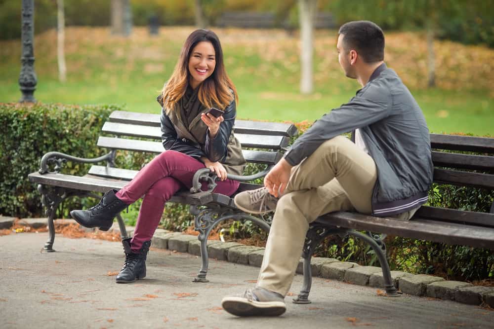 young people sitting on benches