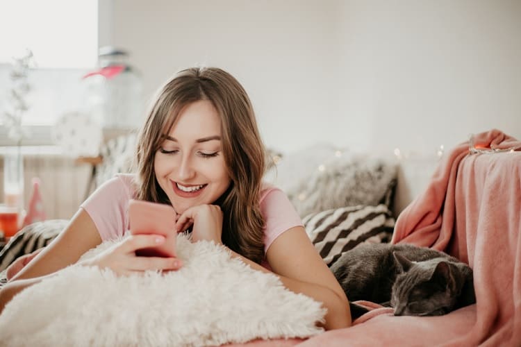 Young Woman Receiving Message On Phone