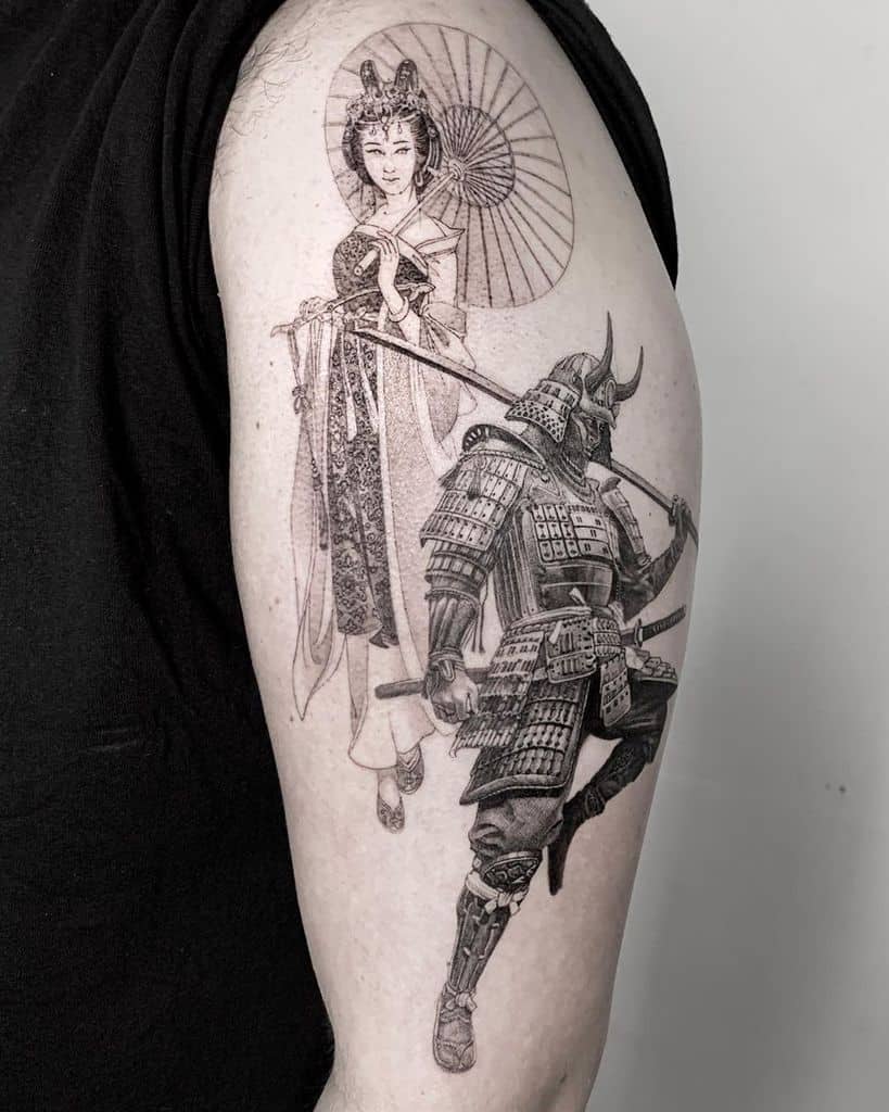 Highly detailed black and gray tattoo of a samurai in full armor wielding a katana, with a graceful Geisha holding a parasol in the background.