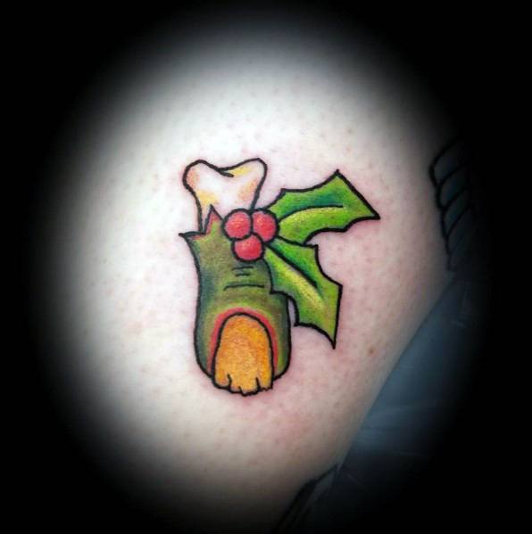 Christmas tattoo of a cartoon-style turkey leg with holly leaves and berries, blending festive holiday cheer with a fun and quirky design.